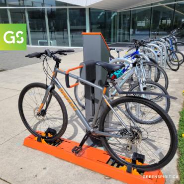 A green technologies bike rack with bike parked