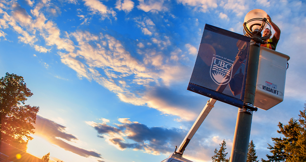 A campus pole banner at the end of Main Mall close to the UBC Rose Garden