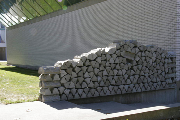 Outdoor art of a pile of wood made of concrete