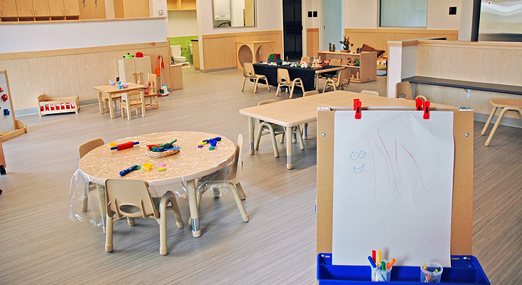 Child-sized tables and toys throughout the 1-2 years area.