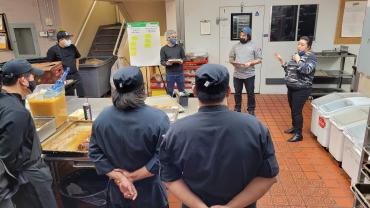 Campus and Community Planning staff presenting Campus Vision 2050 materials in a Residence Hall kitchen.