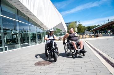 Image of two people on wheelchairs at the UBC bus exchange.
